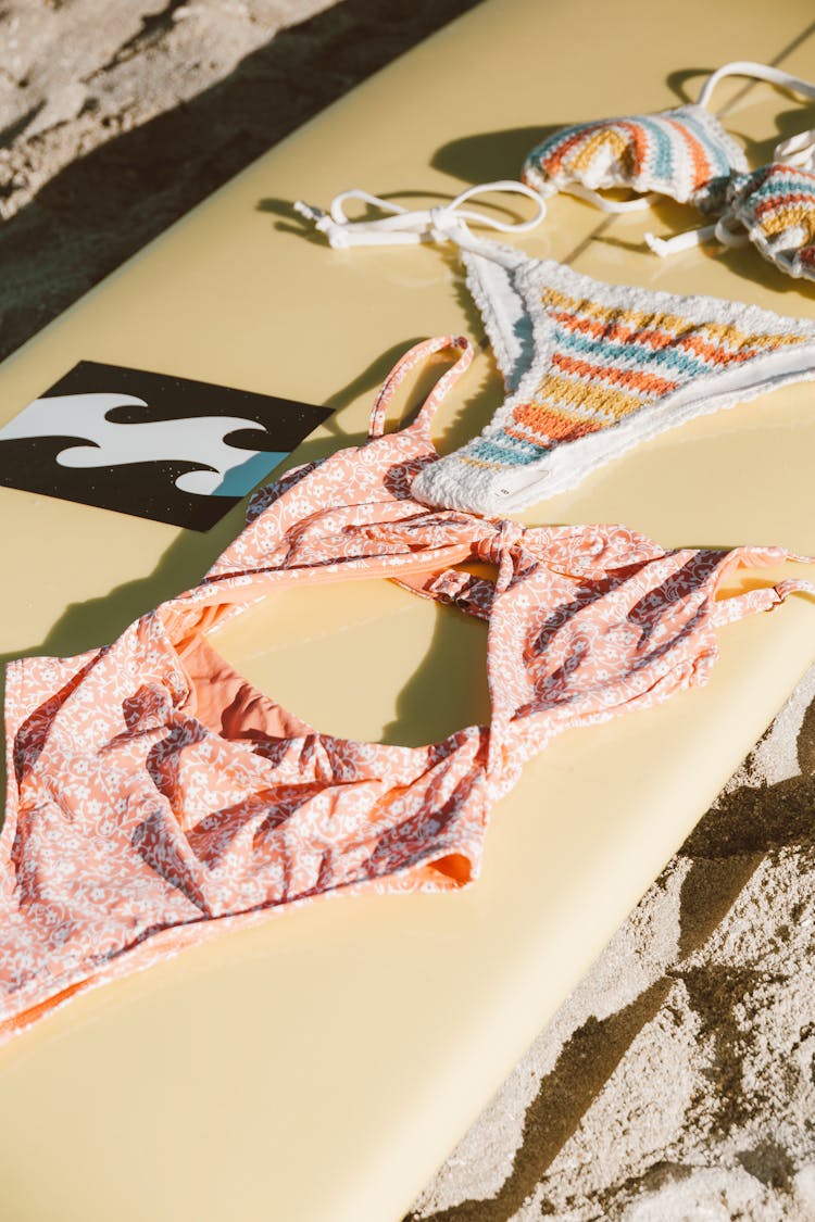 Patterned Bikinis On A Surfboard 