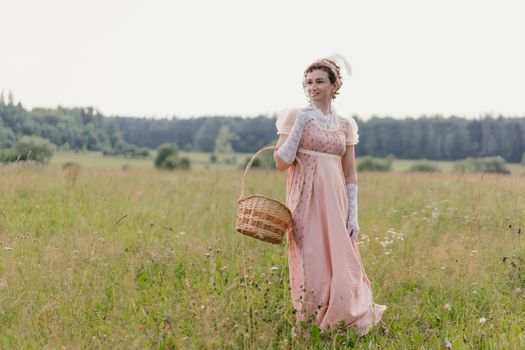 A Woman in Pink Dress Standing on Grass