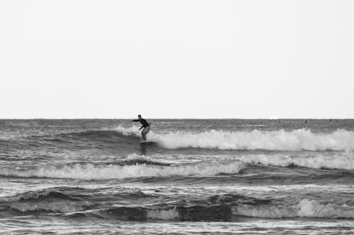 Black and white Picture of a Man Surfing 