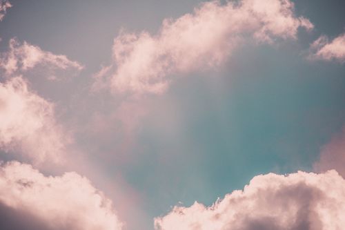 Free A serene and ethereal cloudscape with soft pink clouds against a pastel sky, evoking calmness. Stock Photo
