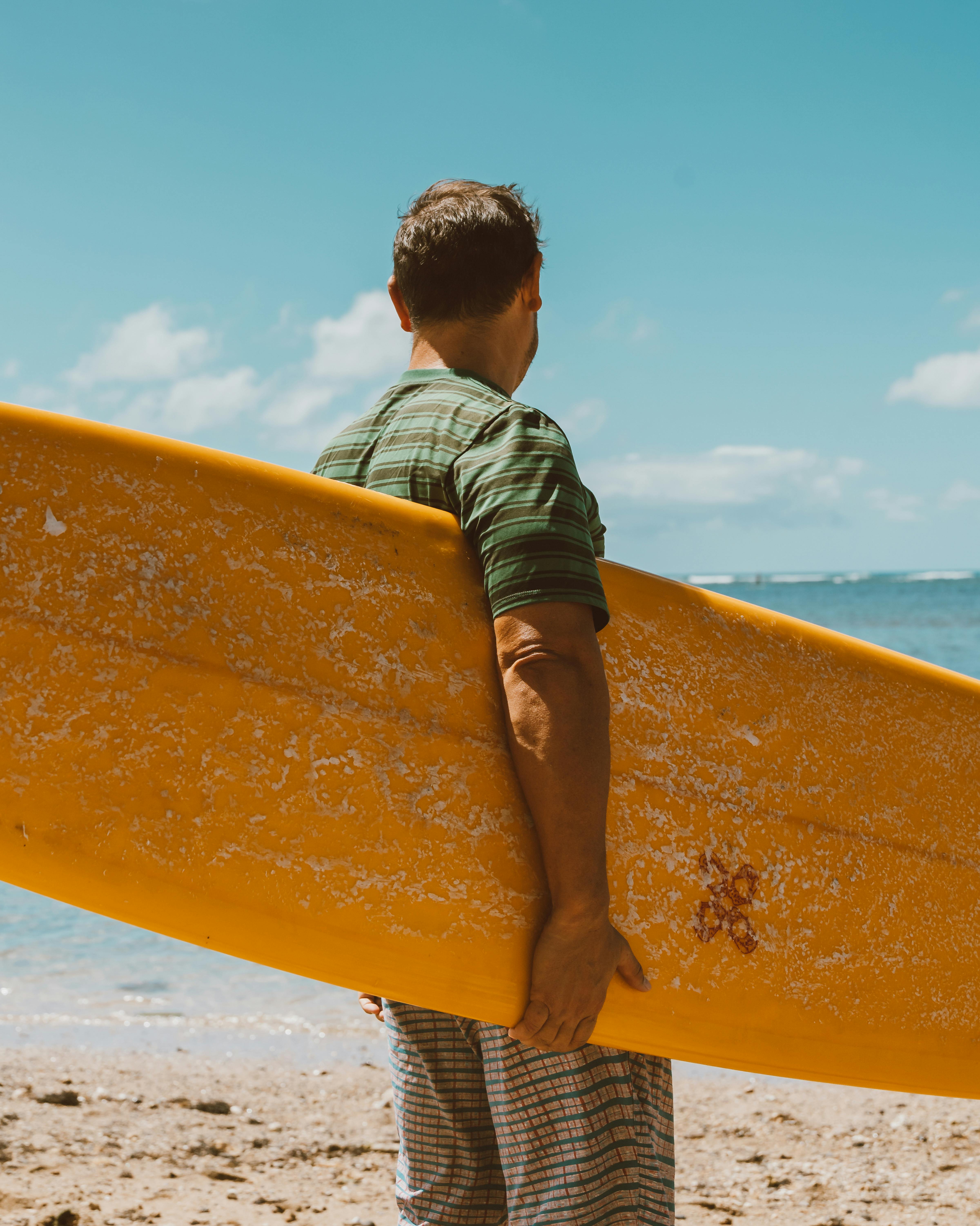 Man Holding Surfboard at Beach · Free Stock Photo
