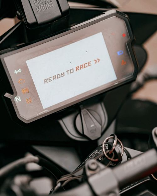 Free Close-up view of a motorcycle dashboard with a 'Ready to Race' message on the screen. Stock Photo