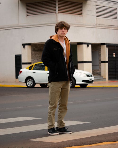 Man Wearing Jacket Standing on Pedestrian Lane