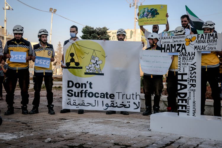 People Holding Protest Signs 