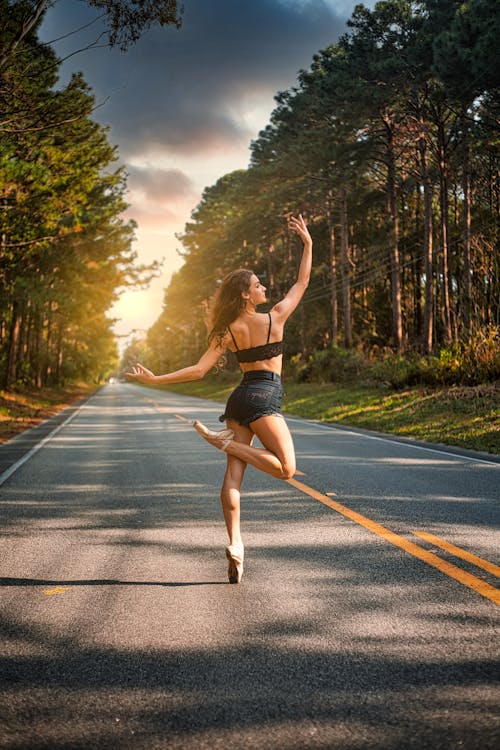 Woman Dancing in the Middle of the Road