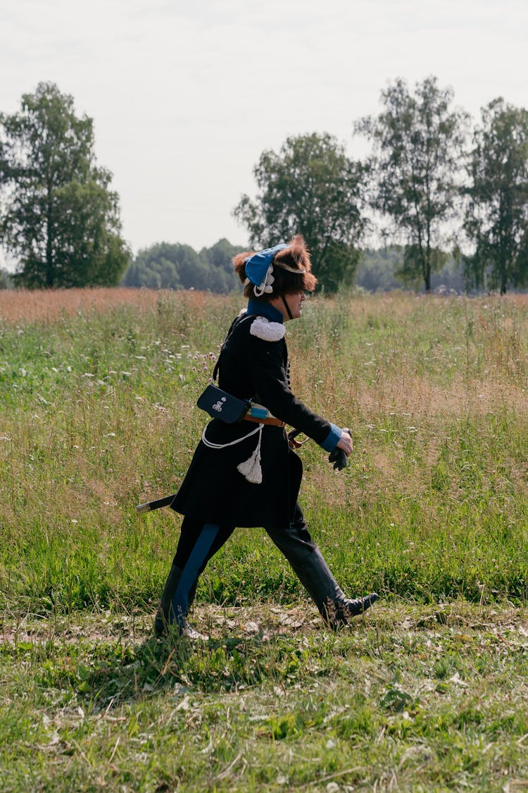 Man In Uniform Walking On The Grass