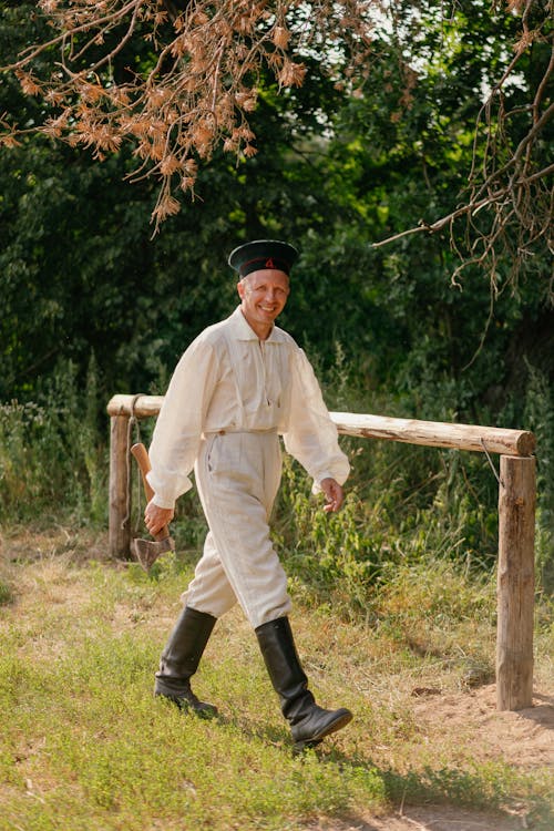 Soldier in a Historical Uniform Walking with a Smile in his Face 