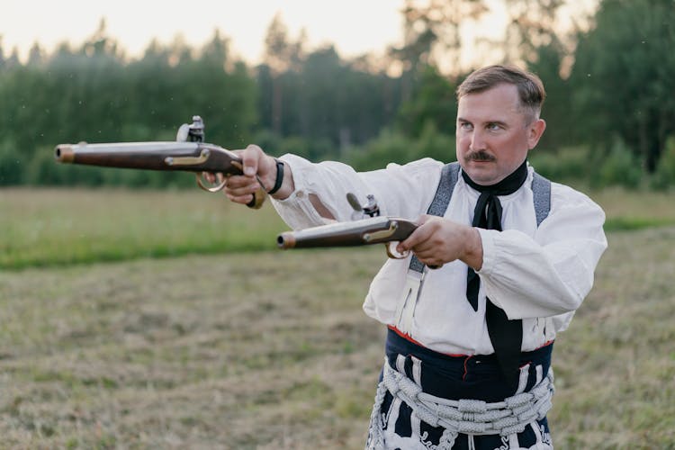 A Man Pointing Guns