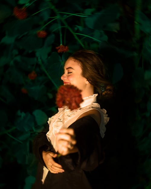 Happy Woman Holding a Flower