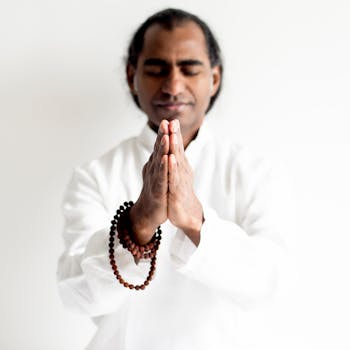 A calm yogi meditating with prayer beads in a peaceful setting.