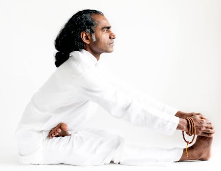 An Indian yogi practices seated forward bend asana, embodying mindfulness and calm.