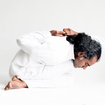 An Indian yogi performs an advanced yoga pose emphasizing flexibility and calmness.
