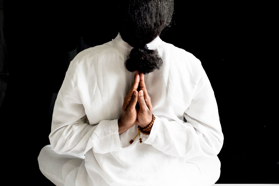Back view of a man meditating in stillness — the neuroplasticity window after ibogaine ceremony requires deliberate integration work to produce lasting change in depression and anxiety