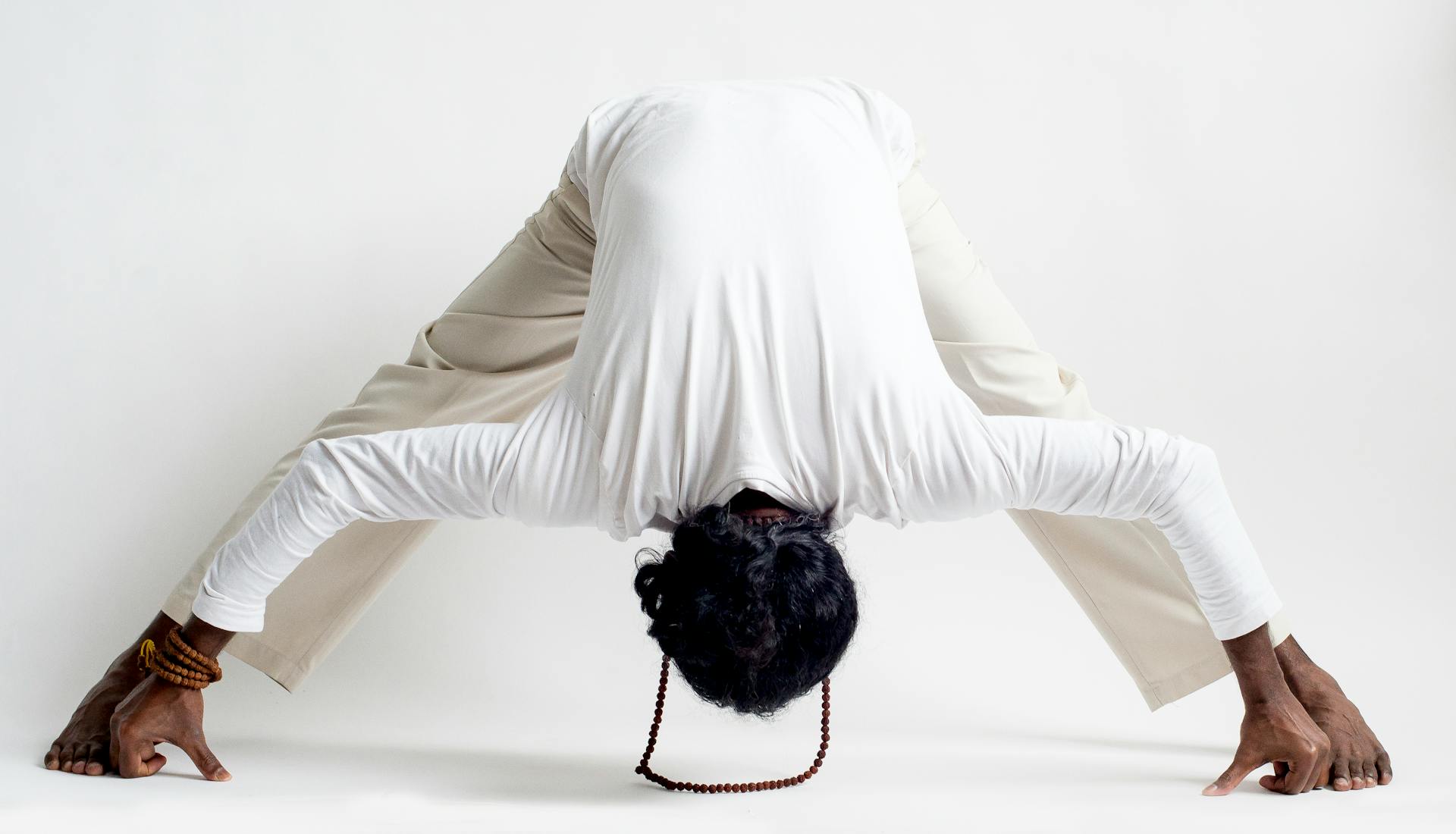 A Man in a White Long Sleeved Shirt doing Yoga