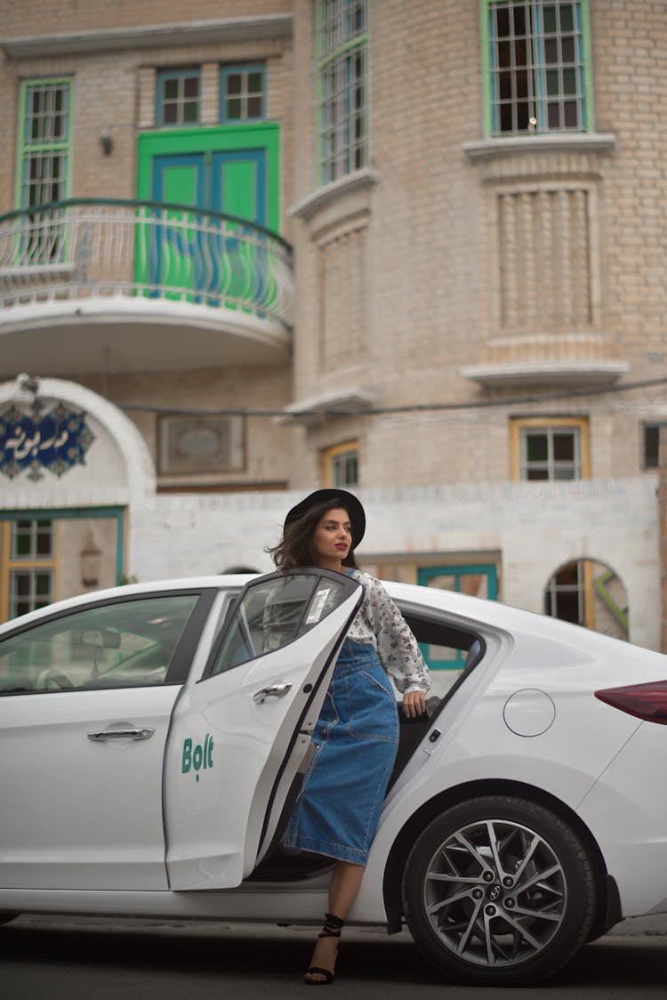 Woman Getting Out Of A White Car