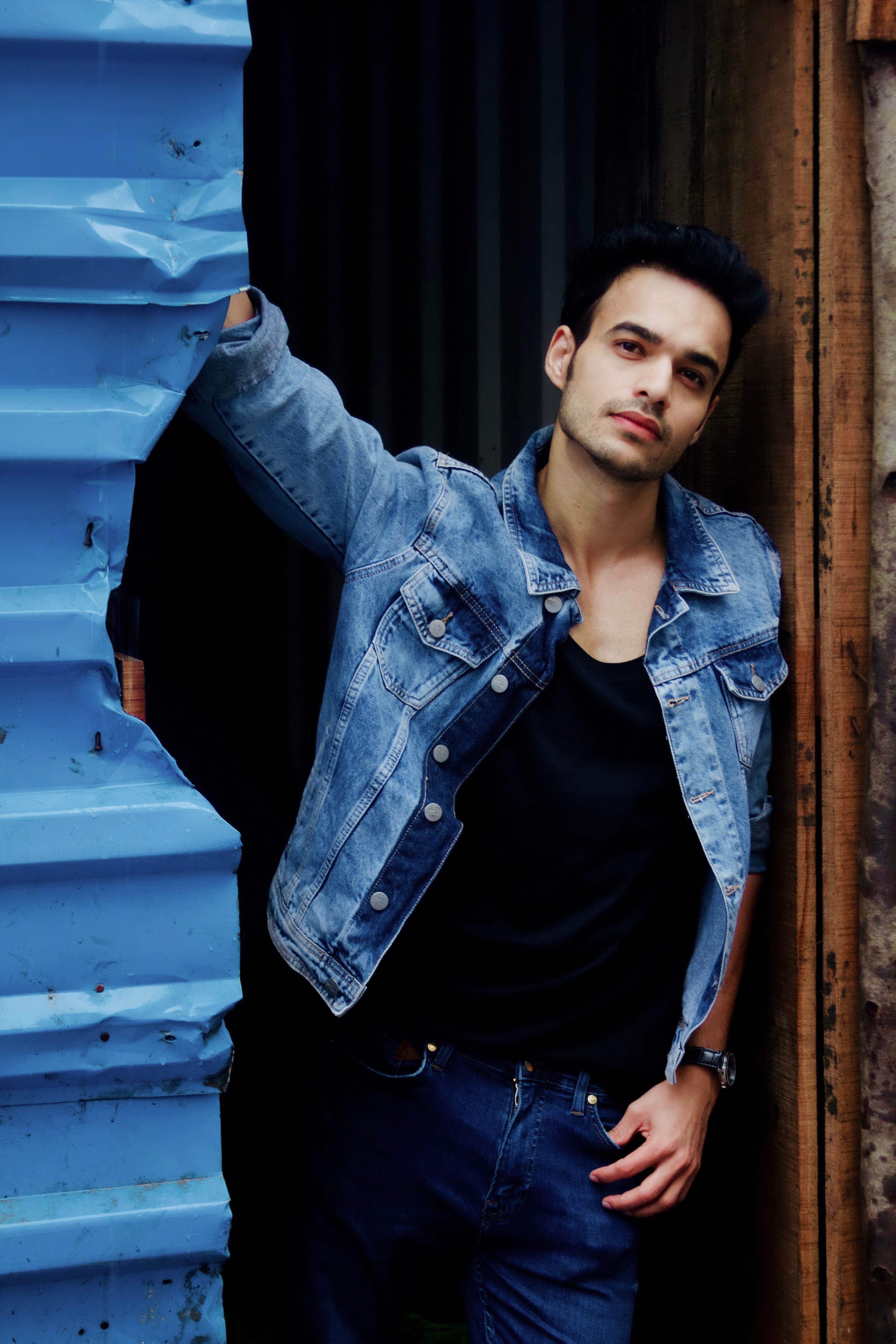 Contemporary young adult fashion with denim outfit in urban setting.