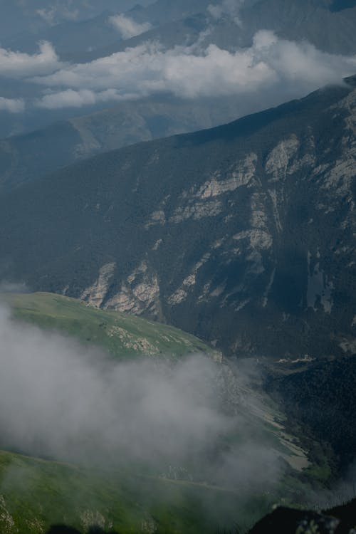 Free Green and Black Mountains Under White Clouds Stock Photo