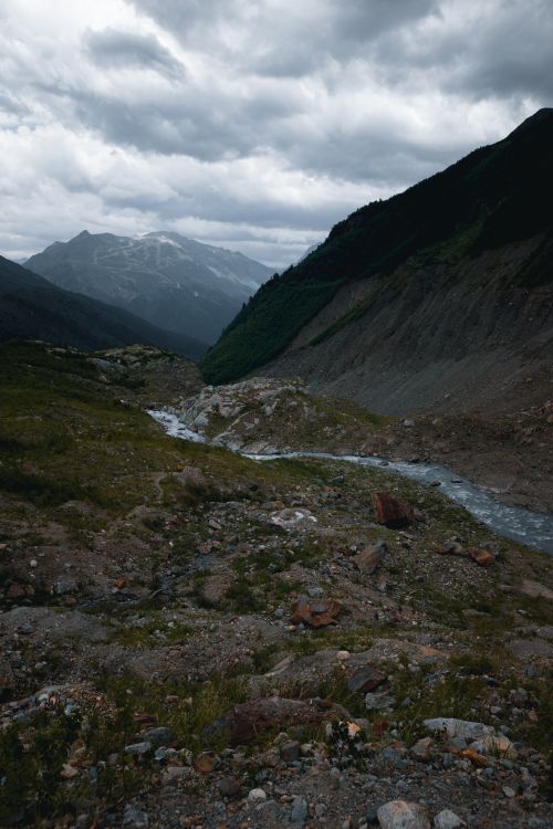 Free Dramatic view of mountain range with rocky foreground and cloudy sky. Stock Photo