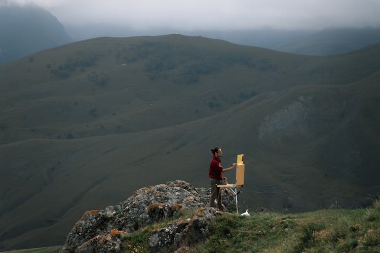 Man In Red Shirt Standing On Rock Mountain Painting The View