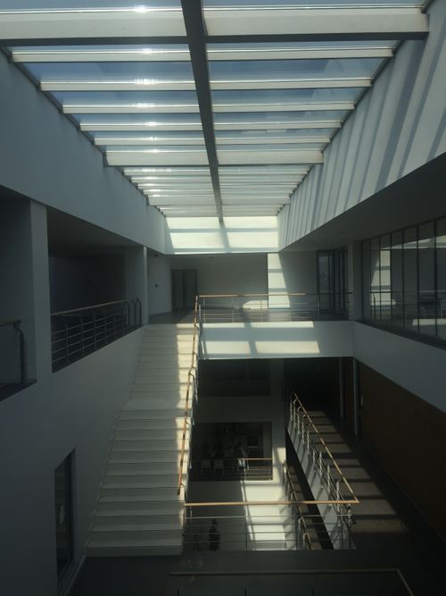 Free Bright interior architecture featuring stairs, skylights, and modern design. Stock Photo
