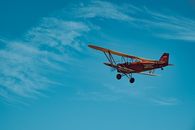 Orange and White Airplane in Mid Air