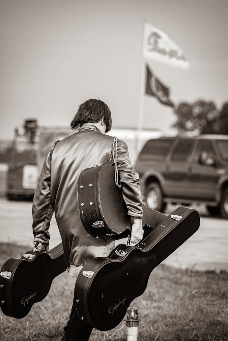 A Man Carrying Guitars