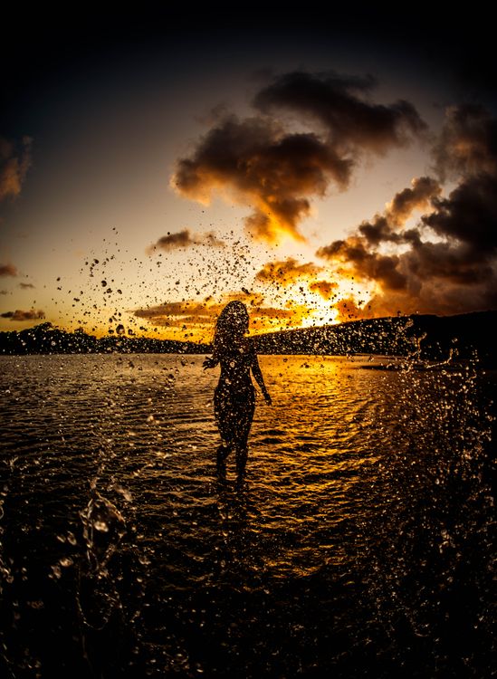Silhouette of a Woman Standing on the Beach during Sunset · Free Stock ...