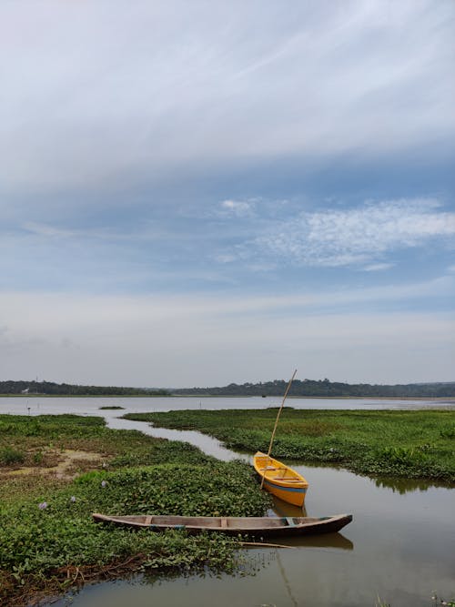 Brown and Yellow Boats on River Under White Clouds