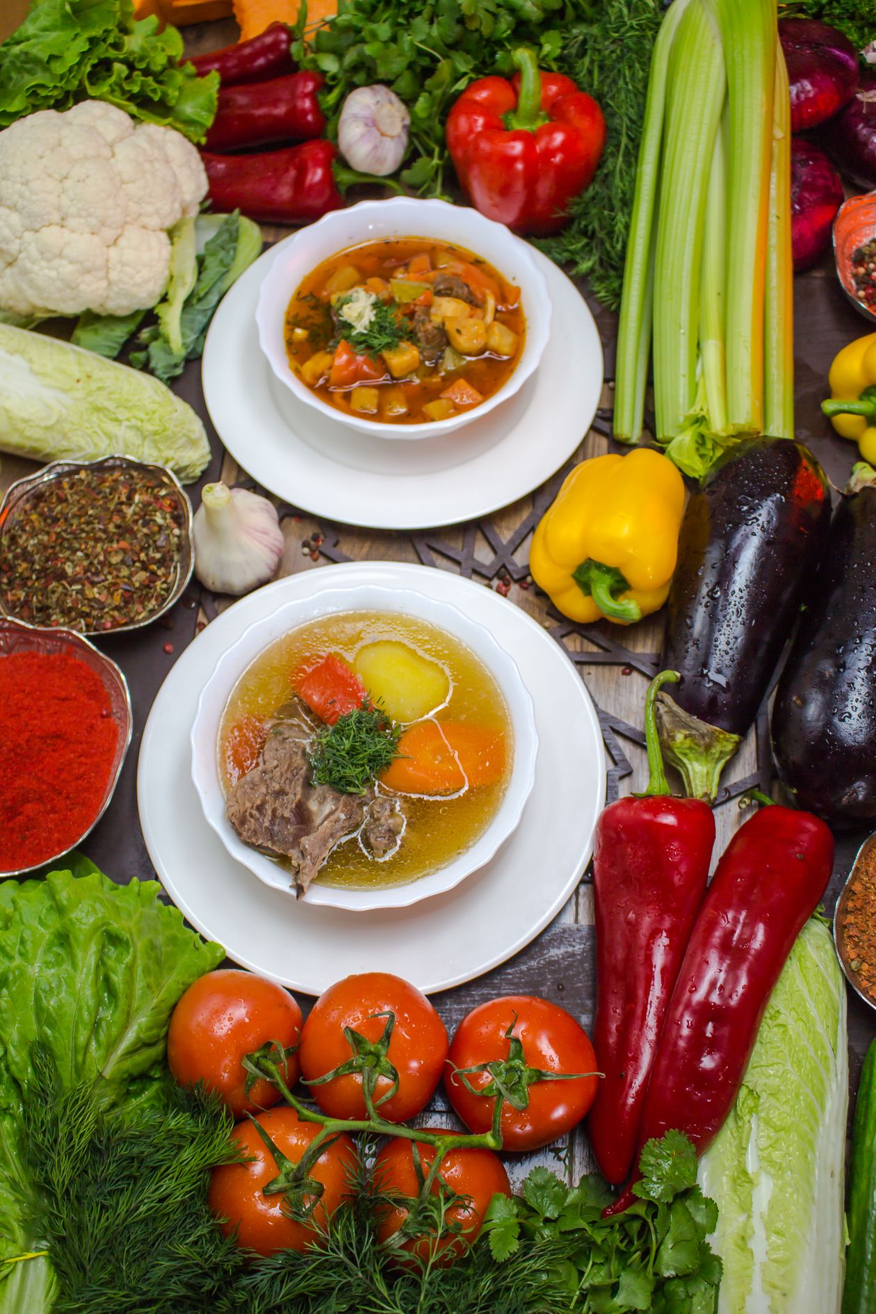 Vegetable beef soup ingredients - fresh peppers tomatoes carrots celery and herbs