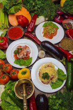 Colorful assortment of fresh organic vegetables and pasta dishes on a rustic table, ideal for healthy food concepts.