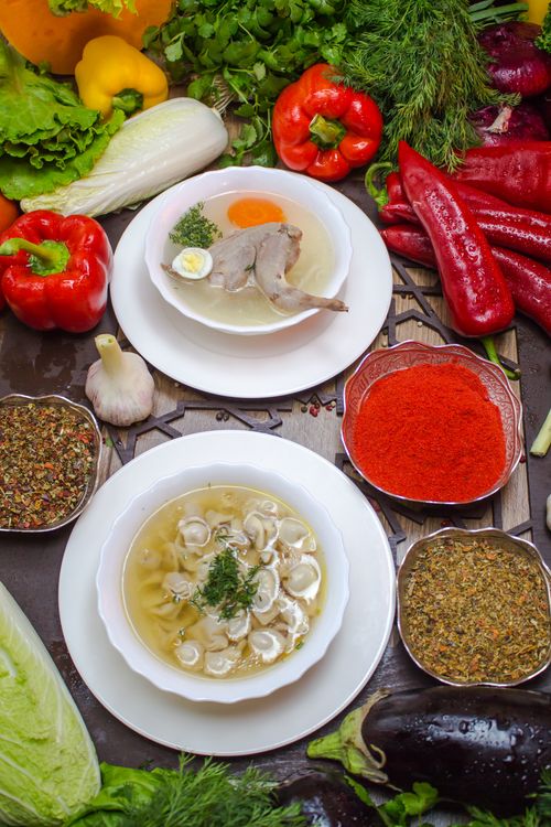 Free A vibrant assortment of vegetable soups surrounded by fresh ingredients, showcasing healthy and organic cooking. Stock Photo