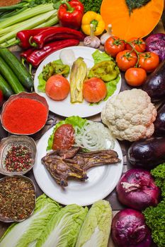 A vibrant assortment of fresh vegetables and a plated meat dish, perfect for healthy eating.