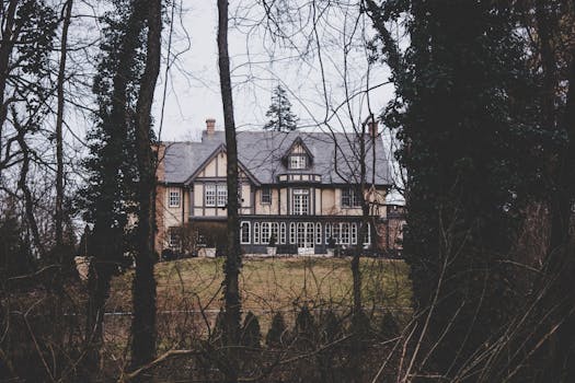 Tudor-style house surrounded by trees, creating a serene and rustic outdoor setting.