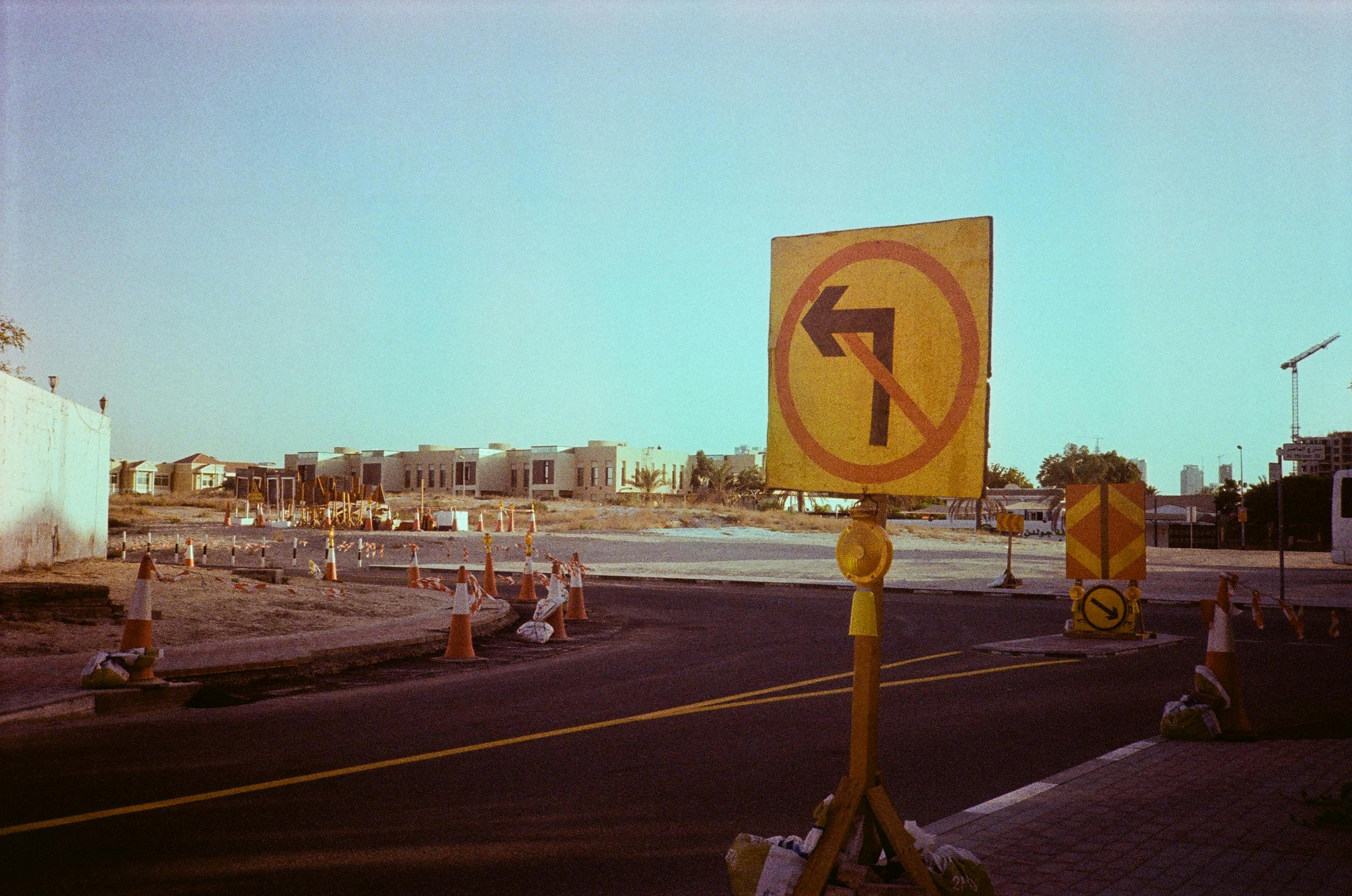 Road construction with traffic signs in Dubai, featuring 'No Left Turn' sign.
