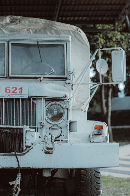 Free Close-up of a vintage military truck's front, captured outdoors during the day. Stock Photo