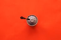 Silver Round Pendant on Orange Surface