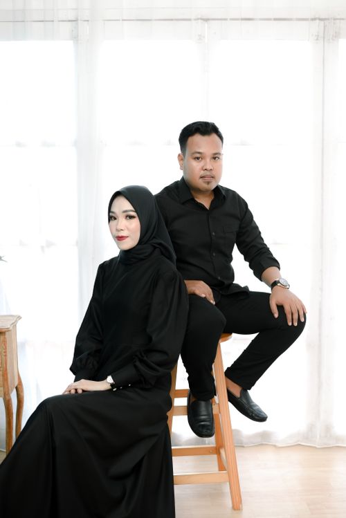 Free Elegant studio portrait of a Muslim couple in black attire, showcasing cultural fashion. Stock Photo