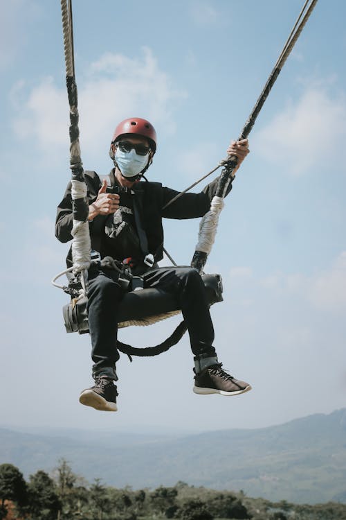 Man in Protective Clothing and in a Harness in Mountains 