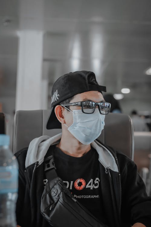 A Man Wearing Eyeglasses and a Face Mask 
