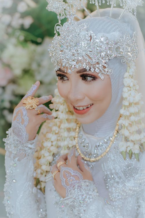 Close-Up Shot of a Woman in White Traditional Dress Smiling