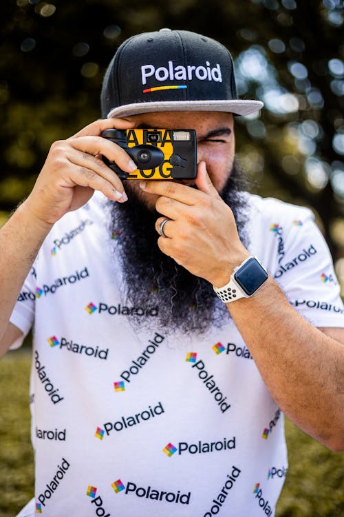 A Man Taking a Picture Using an Analog Camera 