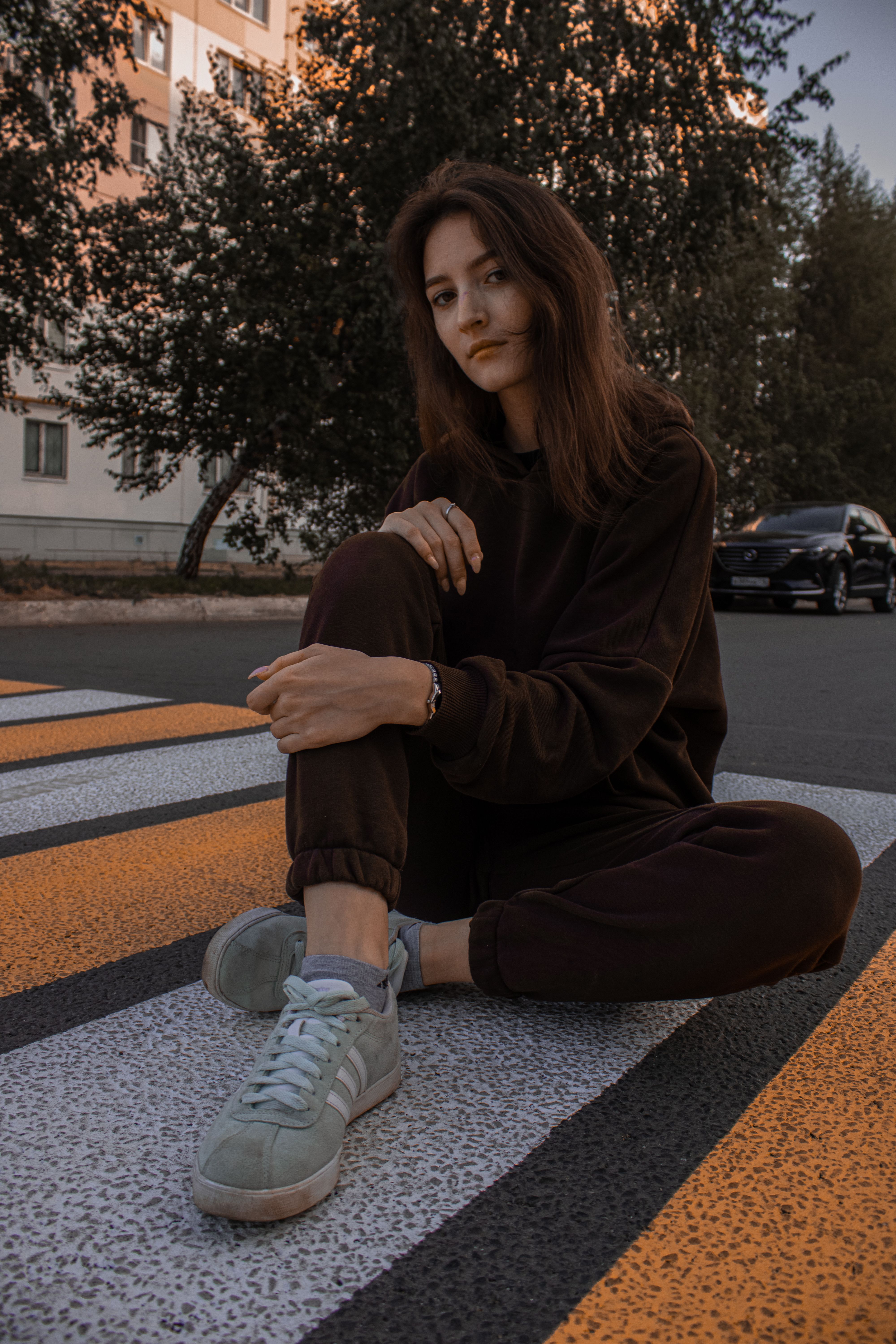 A Woman in Black Sweater Sitting on the Ground · Free Stock Photo
