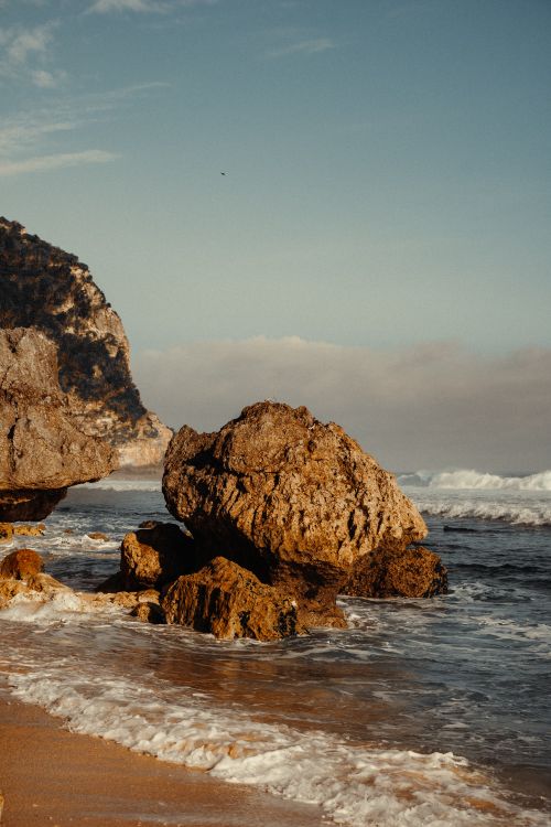 Free Explore the rugged beauty of Bali's coastline with this stunning cliffside beach view. Stock Photo