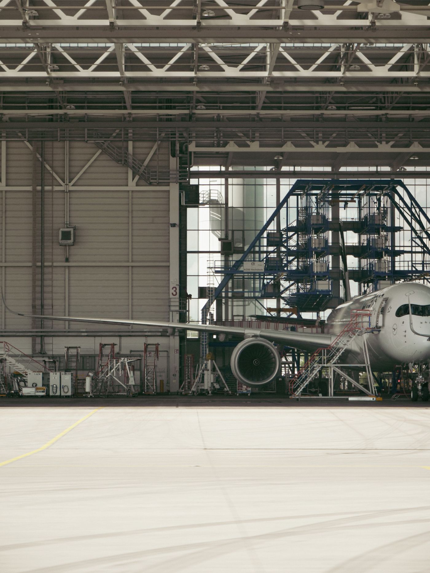 An aircraft parked inside a maintenance hangar — Michel Rothstein on Pexels