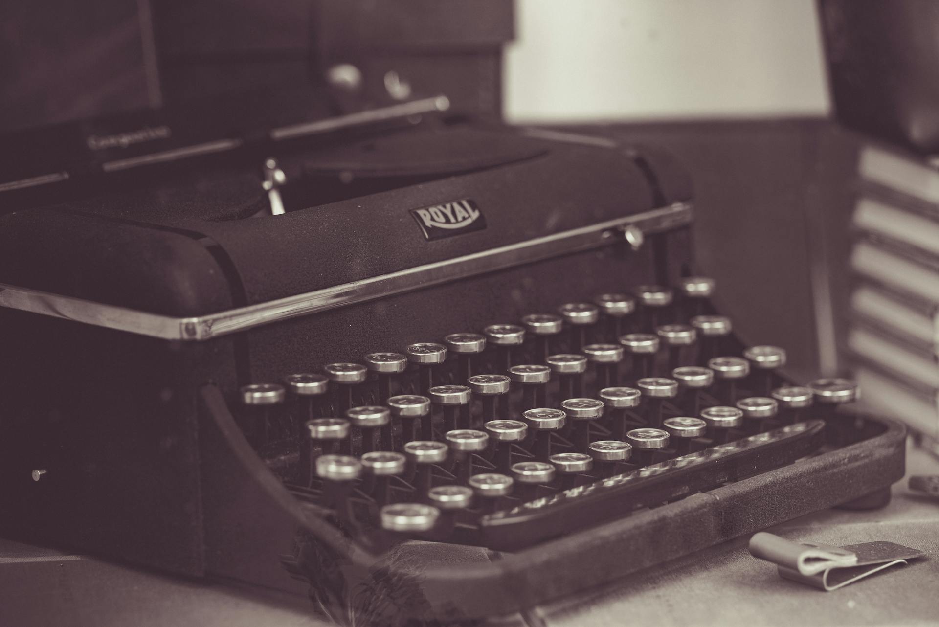 Sepia-toned close-up of a classic Royal typewriter, showcasing vintage elegance.