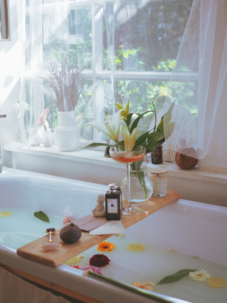 White Bathtub With Bath Essentials On Wooden Tray