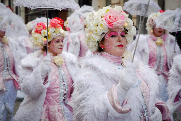 Woman In A Parade Wearing White Baroque Dress With Umbrella 