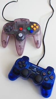 Vintage PlayStation and N64 controllers on a white surface, showcasing gaming nostalgia.