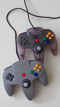 Vertical shot of vintage Nintendo game controllers on a clean white surface.