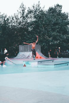 Shirtless skateboarders performing tricks in Istanbul skate park, capturing youthful energy and urban lifestyle.